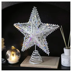 Close-up of glittery champagne star tree topper with sequins and warm ambient lighting
