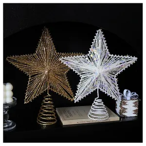 Close-up of glittery champagne gold and silver star tree toppers with spiral metal base