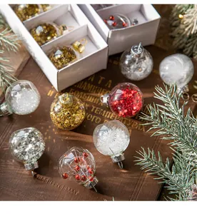 Detailed view of assorted transparent Christmas baubles with glitter and snowflake fillers