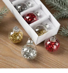 Close-up of clear Christmas ornaments filled with red, gold, and silver sequins.