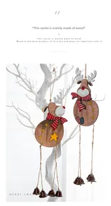 Close-up macro detail of wooden reindeer Christmas ornaments hanging on a white branch