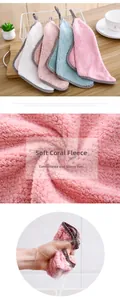 Close-up of coral velvet dishcloth texture and hand squeezing water for absorbency