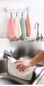 Close-up of coral velvet kitchen cloths showing textures and hanging loop design
