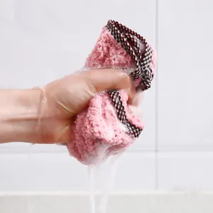 Absorbent coral fleece dishcloth with pineapple pattern and hanging loop in use
