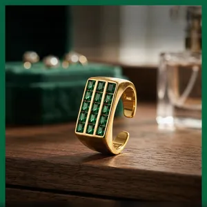 Macro detail of vintage wide gold adjustable ring with emerald-cut green stone matrix