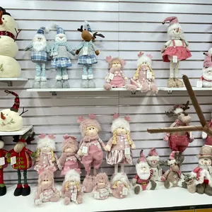 Detailed view of various knitted Christmas snowman and Santa plush dolls for holiday decor