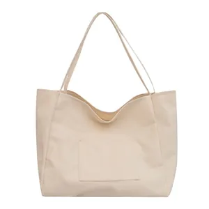 Minimalist cream canvas tote bag with front pocket and large capacity for daily shopping