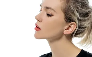 Close-up of 316L stainless steel hinged nose ring and matching small hoops on model