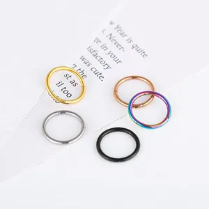 Macro shot of 5 colorful 316L stainless steel hinged rings for nose or lip piercing