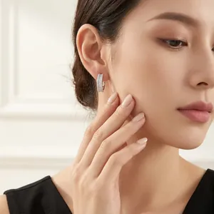 Elegant 925 silver U-shaped hoop earrings with sparkling pave moissanite on a model