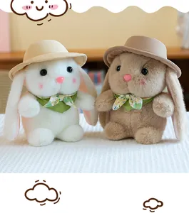 Detail of cute plush bunnies with floral scarves and sun hats in white and brown