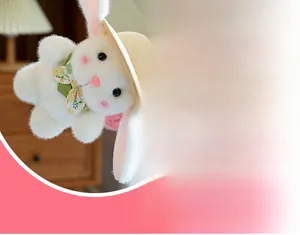 Close-up of white plush bunny with straw hat and floral bowtie in home setting