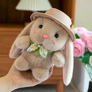 Cute beige long-eared bunny plush doll wearing a brown hat and floral bow tie