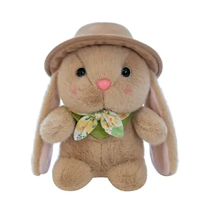 Cute brown plush bunny rabbit wearing a matching hat and floral scarf on white background