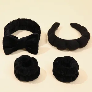Black microfiber spa set including bow headband, padded headband, and wrist wash bands
