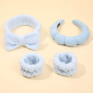 Detail of light blue fuzzy headband and wristband set for face washing and skincare