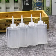Detailed view of four semi-transparent flat plastic bottles with needle tip caps