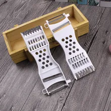 Close-up of white multifunctional 2-piece vegetable peeler and grater set with steel blades