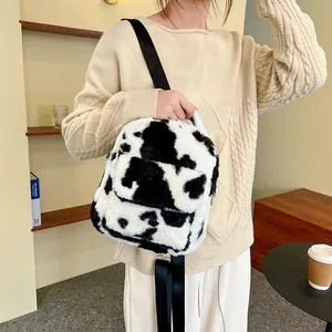 Furry cow print backpack for women featuring plush texture and adjustable nylon straps