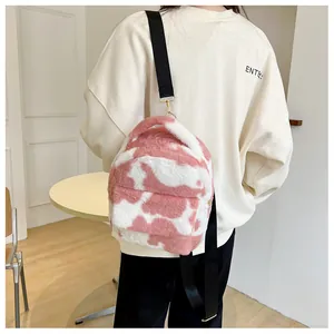 Detail of pink cow print plush mini backpack featuring soft faux fur and adjustable straps
