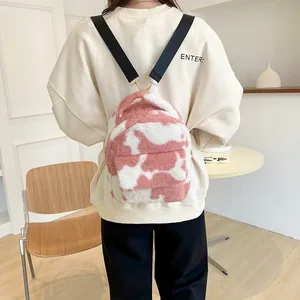 Cute pink cow print plush mini backpack for women featuring soft faux fur and adjustable straps