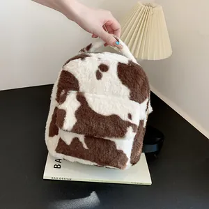 Cute cow print plush backpack for women with adjustable straps and soft faux fur texture