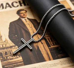 Detailed macro shot of vintage titanium steel cross pendant on a retro newspaper