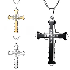 Detailed macro view showing three-layer cross pendants in black, gold, and silver finishes
