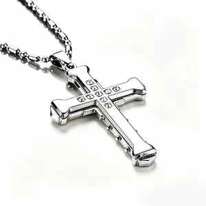 Close-up of a silver cross pendant with a centered crystal on a bead chain
