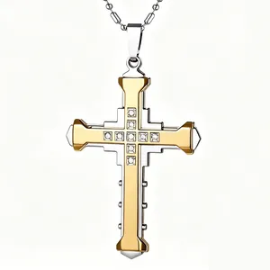 Macro shot of two-tone cross pendant with central diamonds and silver ball chain necklace