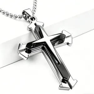 Macro shot of silver cross pendant with black inlay and classic ball chain necklace