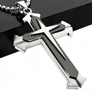 Macro shot of silver and black stainless steel layered cross pendant on a ball chain