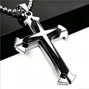 Close-up of a men's layered cross pendant in silver and black with a ball chain link