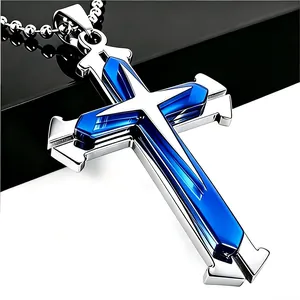 Detailed close-up of a silver cross pendant with blue inlay and round bead chain necklace