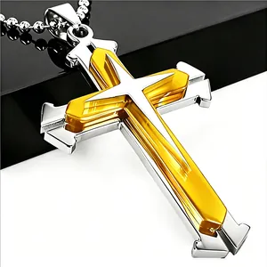 Close-up of dual-layer gold and silver cross pendant with a beaded ball chain necklace