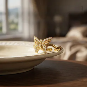 Detailed view of hollow butterfly wing ring with zircons and 18K gold plating