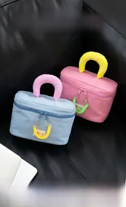 Dual-color cosmetic bag detail showing MiloBliss embroidery and spiral zipper charms