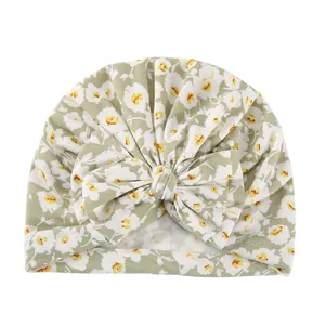 Detailed view of baby floral turban hat featuring a large bow and soft cotton fabric