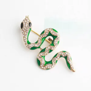 Sparkling green enamel snake brooch with clear rhinestones on gold alloy base