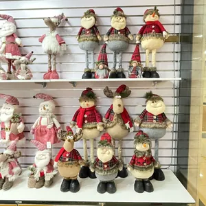 Close-up of Christmas plush dolls featuring red plaid fabric and long fuzzy fur textures