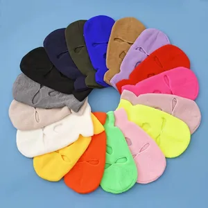 Three-hole knitted balaclavas shown in a diverse range of colors on a blue background