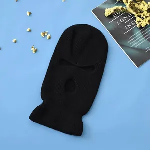 Detailed close-up of a black three-hole knitted balaclava mask showing soft texture