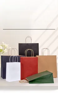 Various colored kraft paper bags with twisted handles in a minimalist lifestyle setting