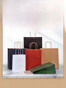 Macro shot of colorful reinforced kraft paper bags with sturdy twisted handles on marble