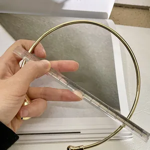 Close-up measuring the 13cm diameter of this gold minimalist metal choker necklace