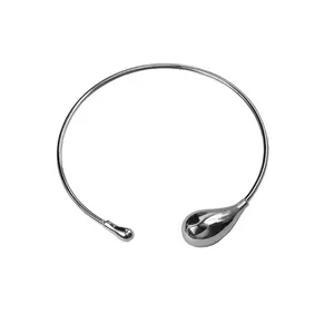 Minimalist silver metal teardrop choker necklace with asymmetric open design on white