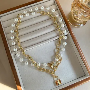 Chic layered necklace set with gold curb chain, square lock pendant and white pearls