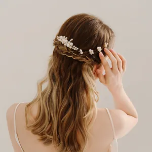 Détails de pinces à cheveux en perles et fil doré dans une coiffure de mariée chic