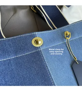 Detailed close-up of hardware lock on a casual denim patchwork tote bag for women
