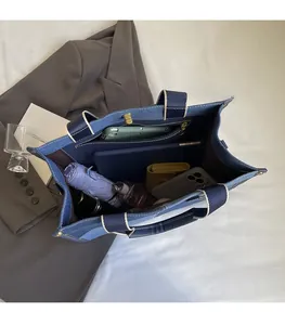 Top view of denim tote bag showing spacious interior with zipper pocket and lining